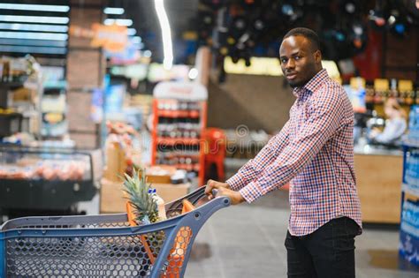 Attractive African American Man Shopping In A Supermarket Stock Photo