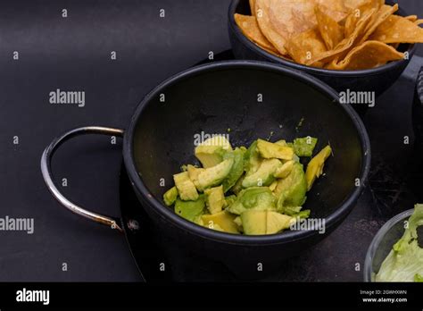 Bowls Of Tortilla Chips And Chopped Avocado On Mexican Comal Stock