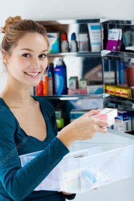 Woman Sorting Old Medicines Stock Image C033 0596 Science Photo