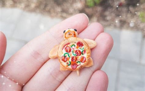 A Cute Pizza Turtle Charm With Pepperoni Cheese And Peppers On Top