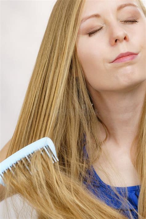 Blonde Girl Combing Her Long Messy Hair Stock Photo Image Of Loss Long