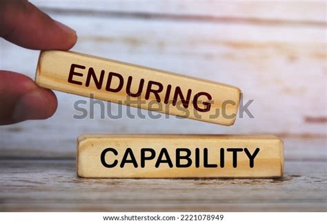 Hand Holding Wooden Blocks Text Enduring Stock Photo 2221078949