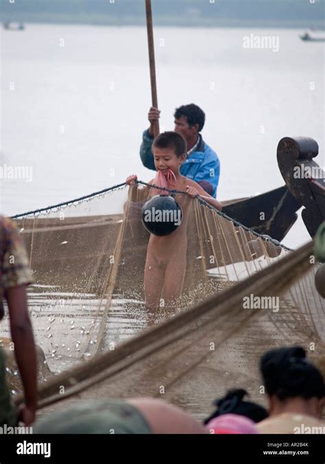 Naked Boy Assisting With Working The Fish Nets Near Mandalay In Myanmar Stock Photo Alamy