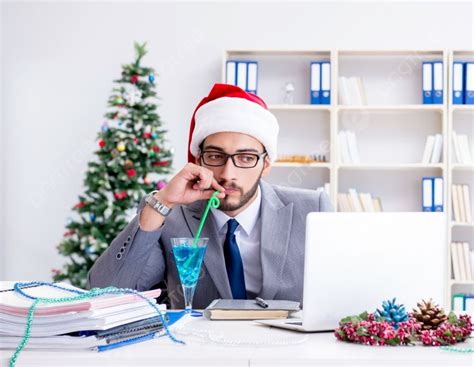 The Young Businessman Celebrating Christmas In The Office Young