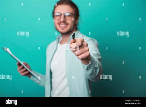 Happy Businessman Wearing Eyeglasses Smiling And Writing In Notepad