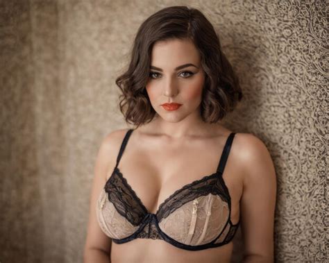 Premium Photo A Woman In Lingerie Posing Against A Wall