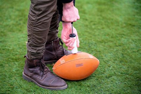 man pumping air into american football ball 12713231 Stock Photo at ...