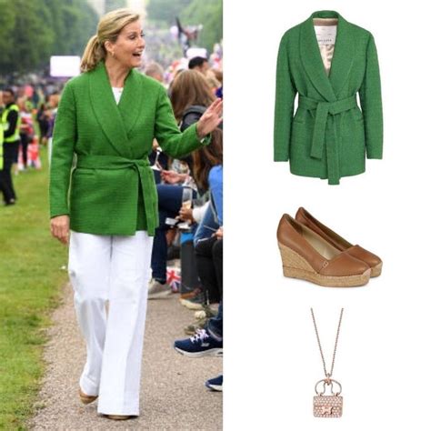 A Woman In Green Jacket And White Pants Walking Next To A Bunch Of