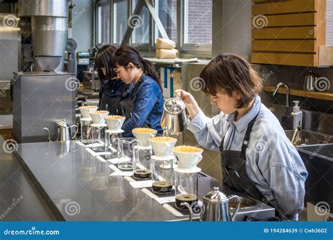 Tokyo Japan Baristas Making Hand Drip Or Pour Over Coffee In Blue