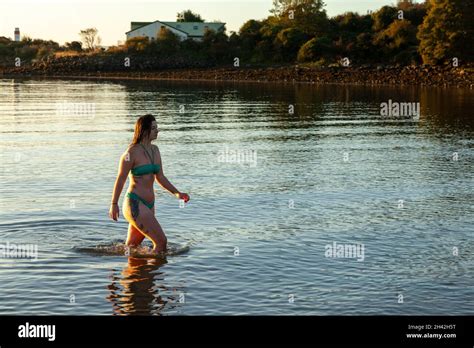 A Woman Wearing A Bikini Walking Out Of The Sea After A Cold Water Swim In The Firth Of Forth