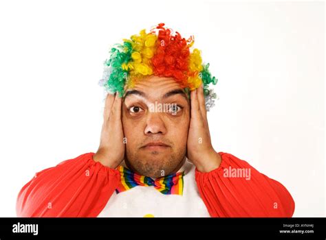 Head And Shoulders Portrait Of A Surprised Midget Clown Hands On Ears