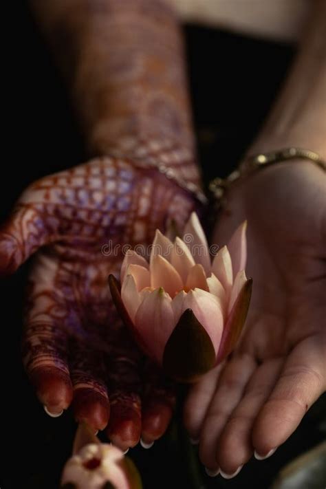 Mehndi Adorns The Women X S Hands With A Beautiful Flower Design