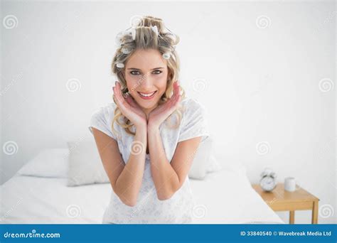 Smiling Attractive Blonde Wearing Hair Curlers Posing Stock Photo