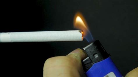 Premium Photo | Hand lighting lighter cigarette closeup burning ...