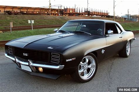 A Black Muscle Car Parked On The Side Of The Road