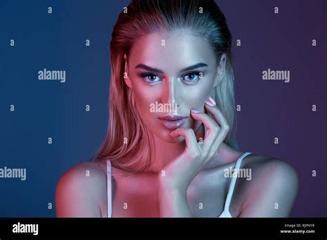 Gorgeous Girl With Make Up And Blonde Hair Posing With At Dark Blue Background Close Up Beauty
