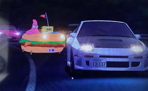 A Car Driving Down A Street Next To A Hamburger