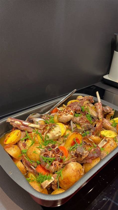 A Pan Filled With Food Sitting On Top Of A Stove