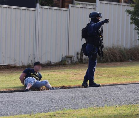 A Nsw Police Force Tactical Operations Unit Officer With A Suspect