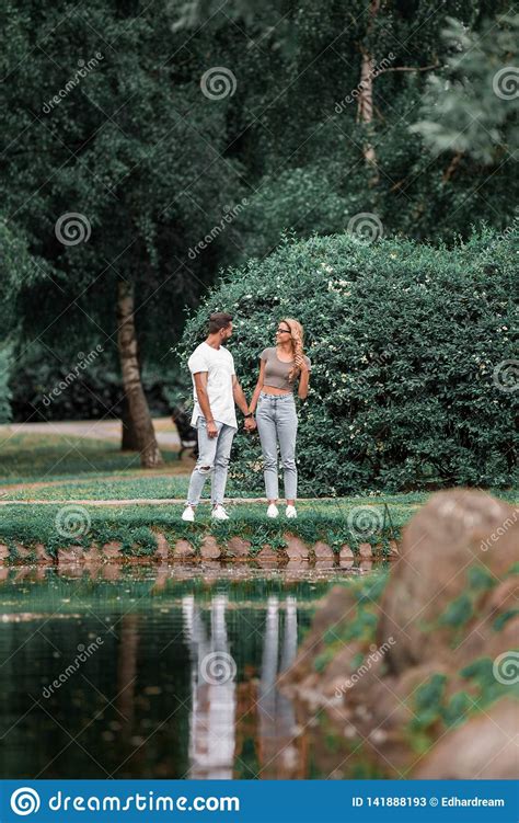 Loving Couple Standing Near A Lake In A City Park Stock Image Image