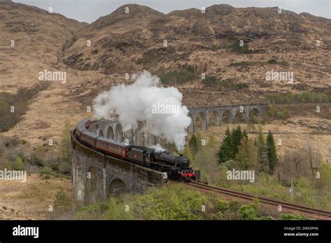 Glenfinnan Railway Viaduct With A Steam Train Crossing The Famous