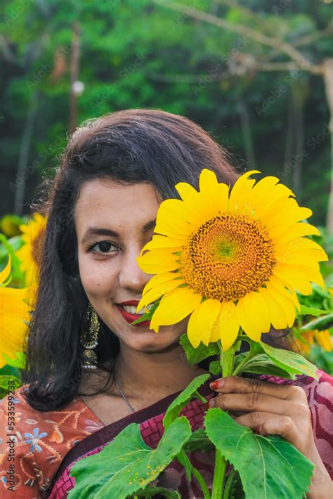 Beautiful young girl enjoying nature on the field of sunflowers. Girl ...