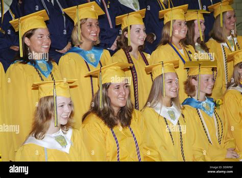 High School Students Sit In Their Caps And Gowns During Graduation