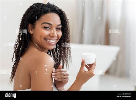 Self Care Concept Young Black Woman Applying Moisturising Body Lotion