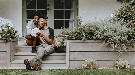 Premium Photo Cute Black Couple Reading A Book Together In A Garden