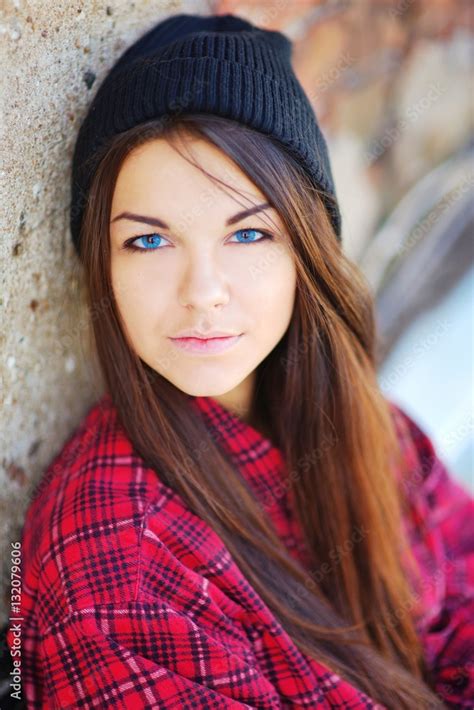 A Pretty Young Blue Eyed Brunette Girl In A Red Tartan Blouse And A