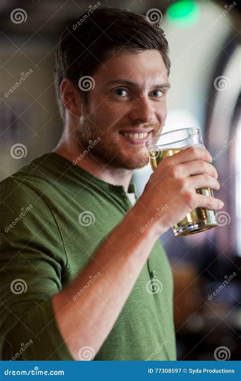 Cerveja Bebendo Do Homem Feliz Na Barra Ou No Bar Imagem De Stock