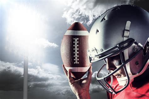 Premium Photo Sportsman Looking Down While Holding American Football