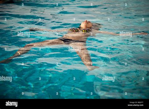 Junge Frau im Schwimmbad auf Rücken mit bunten Bikini treiben Stockfotografie Alamy