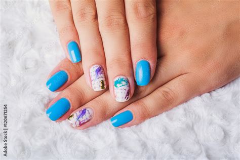 Light blue nail art with feathers print Stock Photo | Adobe Stock