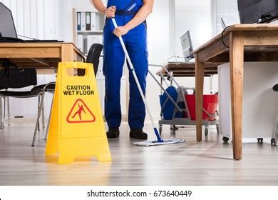 Low Section Male Janitor Cleaning Floor Stock Photo Edit Now