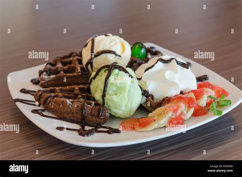 ice cream , chocolate waffles with chocolate sauce and whipping cream ...