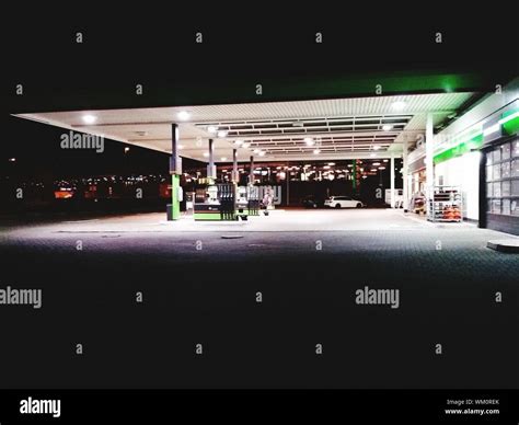 Illuminated Gas Station At Night Stock Photo - Alamy