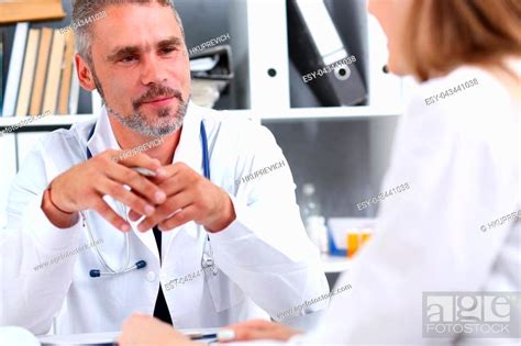 Smiling Handsome Mature Doctor Communicate With Patient Holding Silver