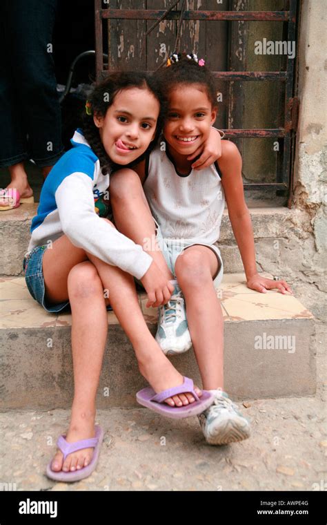 Two Girls Sitting On A Step Havana Cuba Caribbean Stock Photo