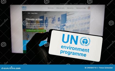 Person Holding Cellphone With Logo Of United Nations Environment Programme Unep On Screen In