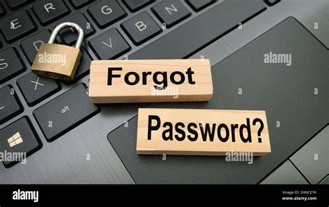 Close Up View Of Text On Wooden Blocks Forgot Password With Blurred Locker And Laptop