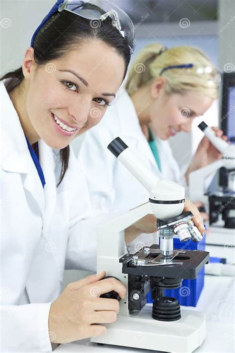 Female Scientists Using Microscopes In Laboratory Stock Image Image