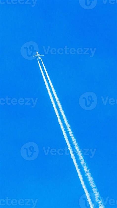 Two Engined Airplane During Flight In High Altitude With Condensation