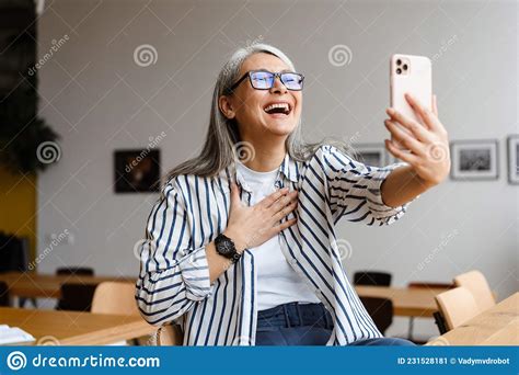 Cheerful Woman Laughing And Taking Selfie Photo On Cellphone Stock