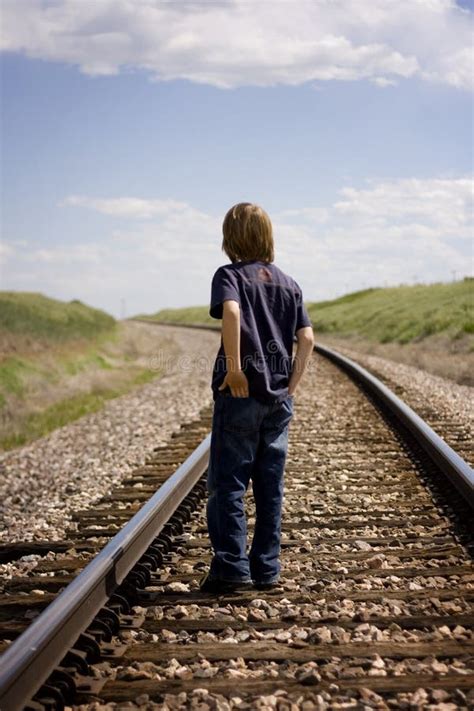 Boy Standing Between Railroad Tracks Stock Photo Image Of Track Rail