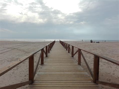 Premium Photo Empty Jetty Leading To Sea Against Cloudy Sky