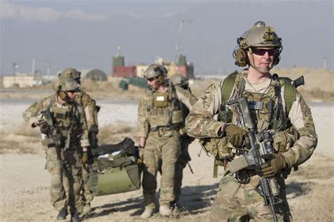 Air Force Pararescuemen Carry Rescue Gear And Assess Their Surroundings