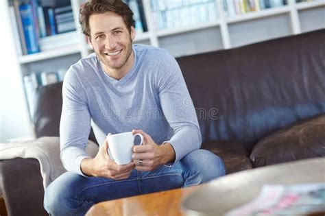 Portrait One Handsome Man Sitting Alone On The Sofa In His Living Room