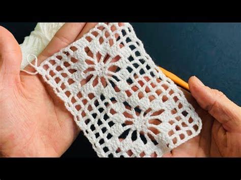 Someone Is Holding A Crochet Doily In Their Hands With A Yellow