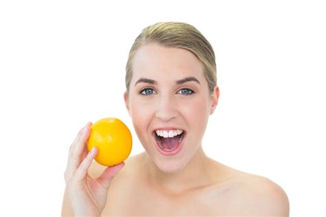 Premium Photo Surprised Attractive Blonde Holding Orange